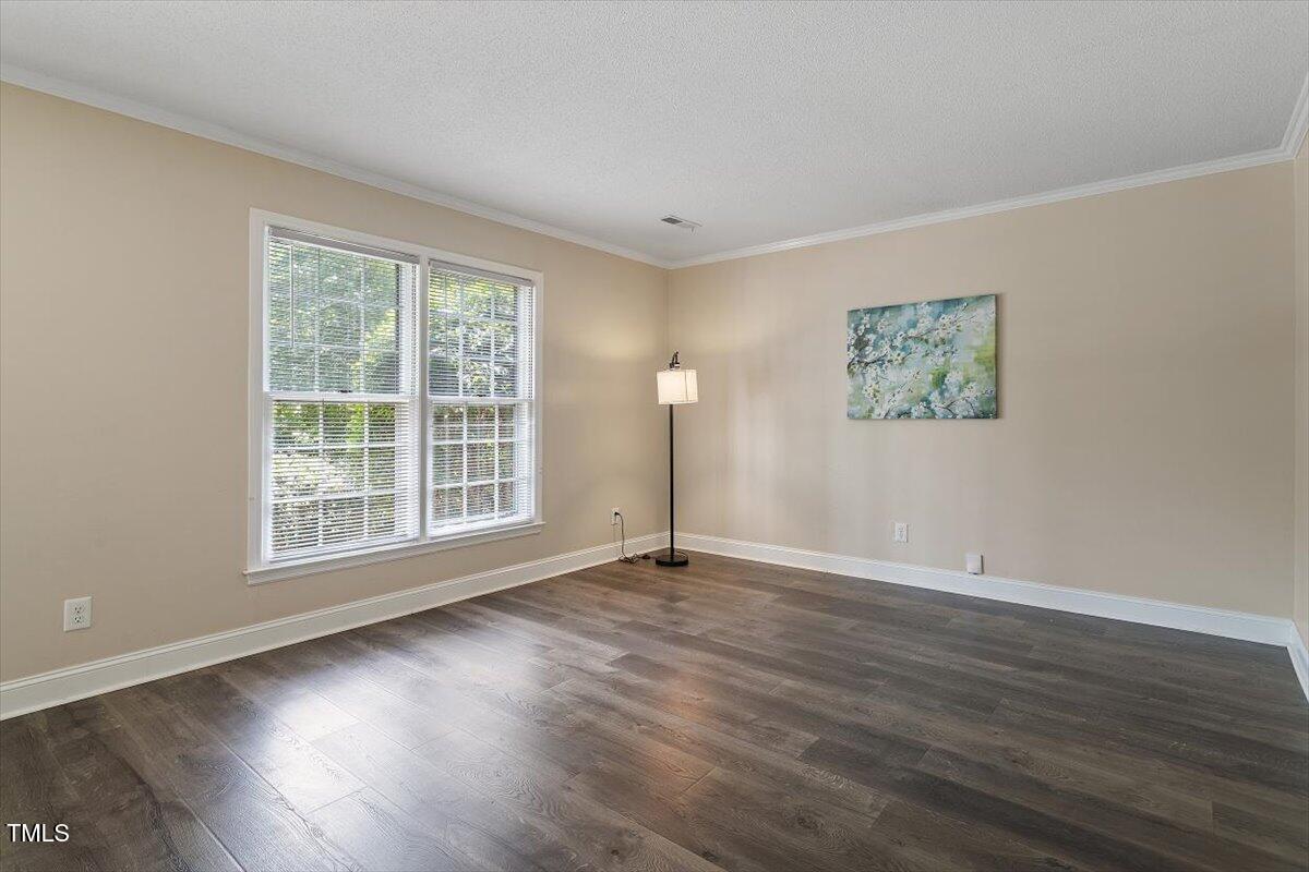 5309 Covey Court Raleigh, NC 27609 - Photo 30 of 47 a view of an empty room with wooden floor and a window