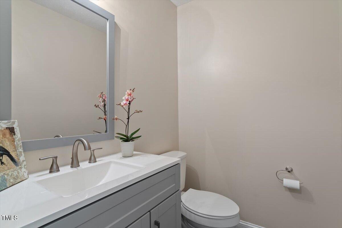 5309 Covey Court Raleigh, NC 27609 - Photo 33 of 47 a bathroom with a sink a toilet and a mirror