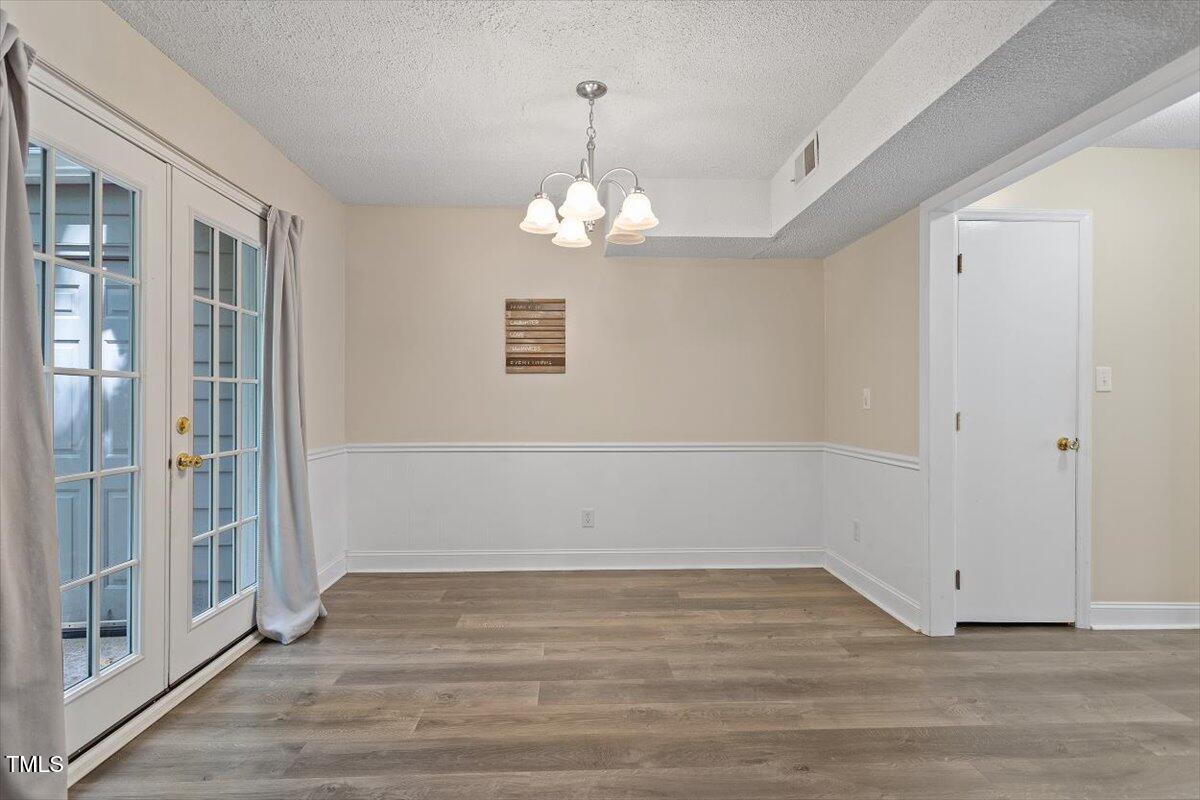5309 Covey Court Raleigh, NC 27609 - Photo 35 of 47 a view of empty room with wooden floor