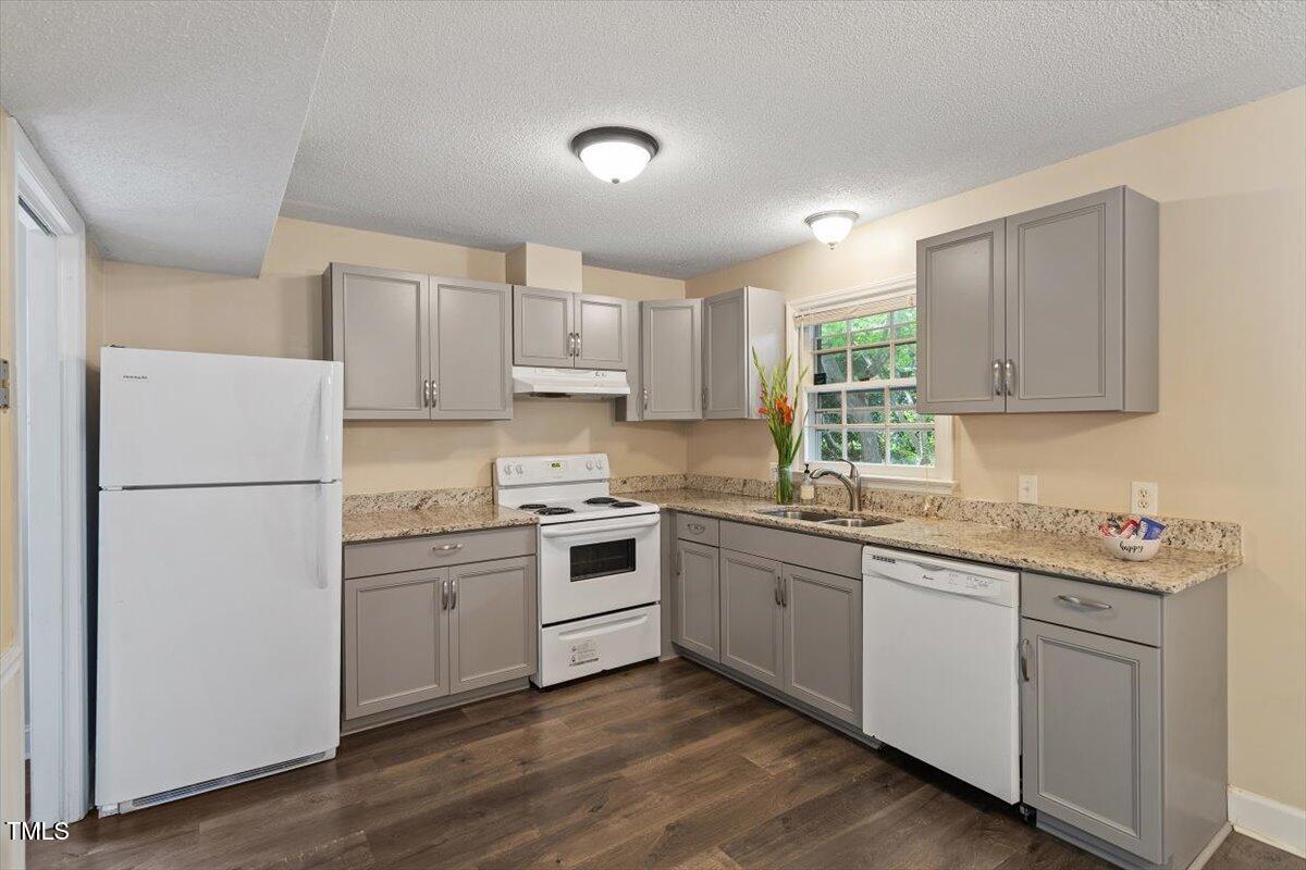 5309 Covey Court Raleigh, NC 27609 - Photo 36 of 47 a kitchen with a sink stove and refrigerator