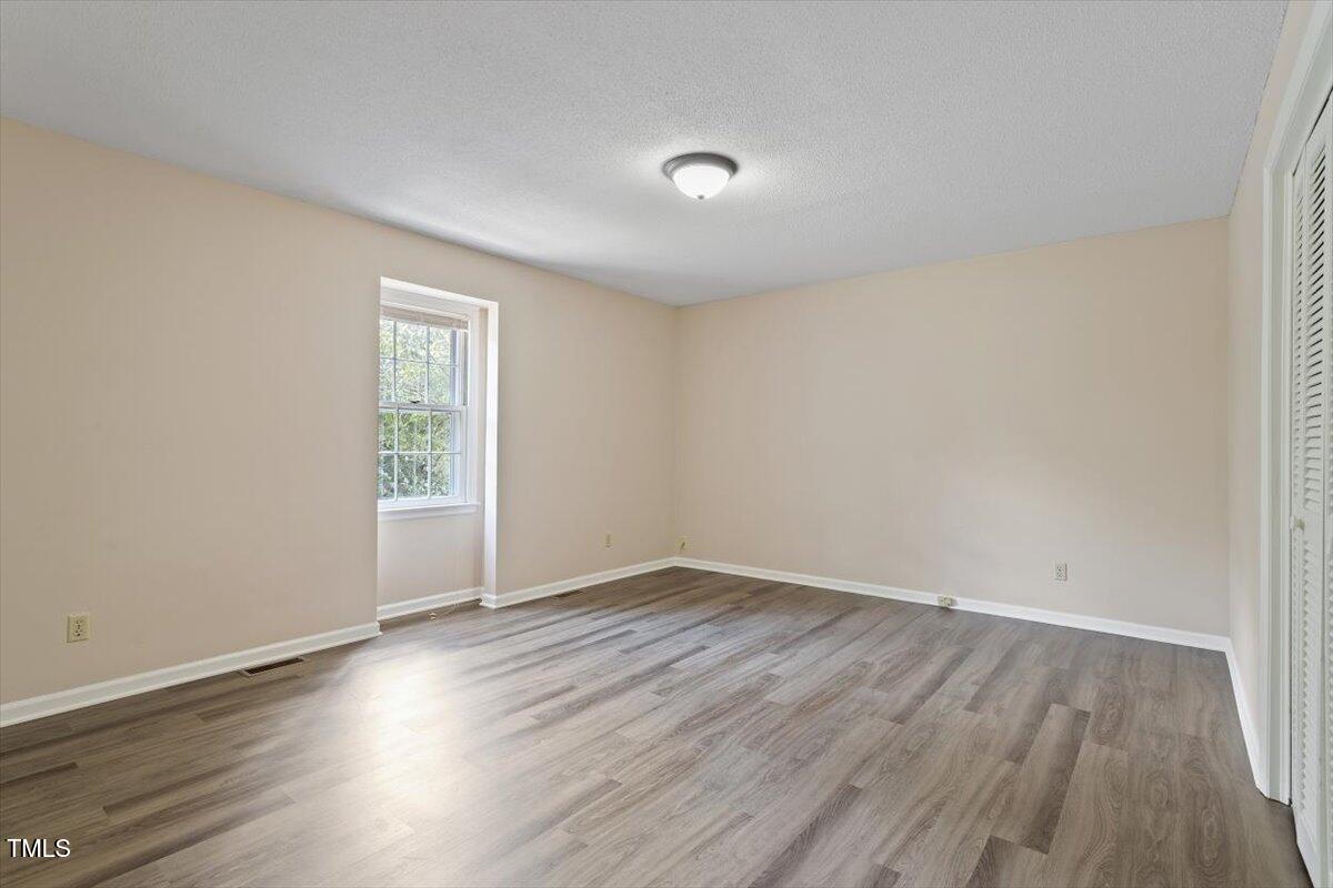 5309 Covey Court Raleigh, NC 27609 - Photo 42 of 47 an empty room with wooden floor and windows