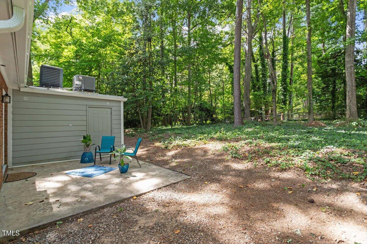 5309 Covey Court Raleigh, NC 27609 - Photo 4 of 47 a view of a small house with yard and a tree