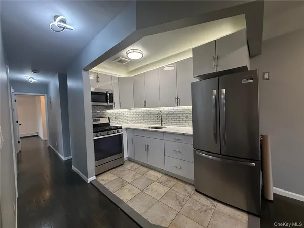 a kitchen with a refrigerator and a sink