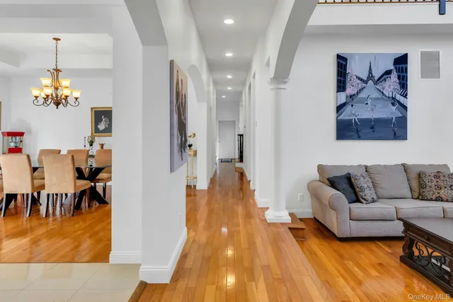 a living room with furniture and a chandelier