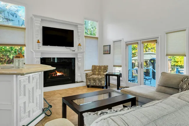 a living room with furniture a flat screen tv and a fireplace