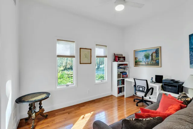 a living room with furniture gym equipment and a window