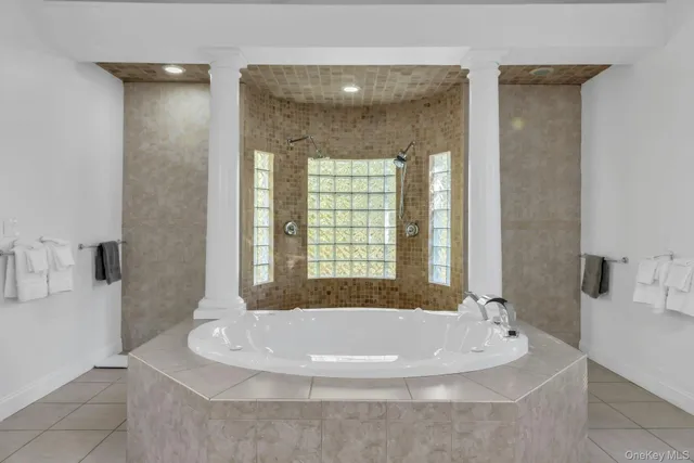 a bath tub sitting in a bathroom next to a window