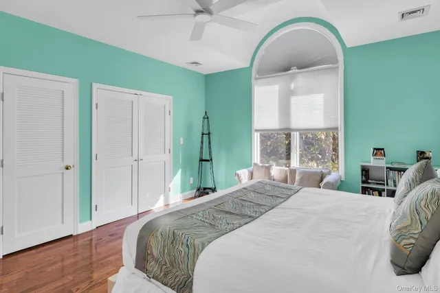 a bedroom with a bed and a large window