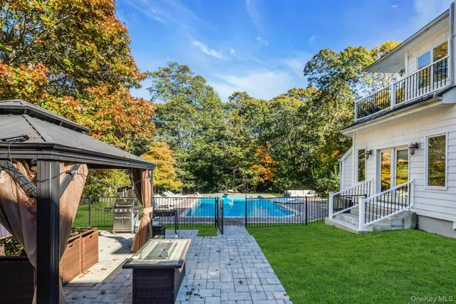 a view of a patio with couches chairs potted plants and large tree