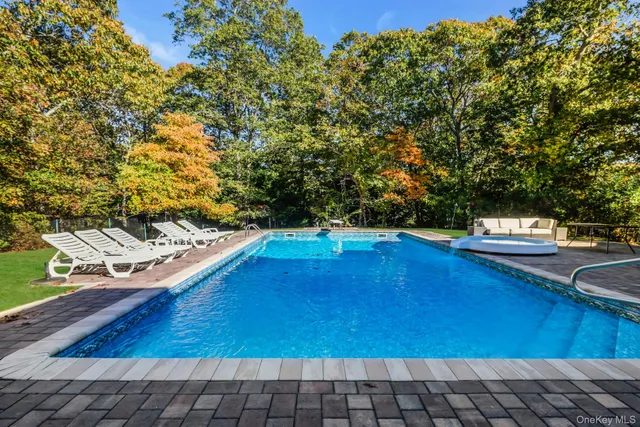 a view of a backyard with sitting area