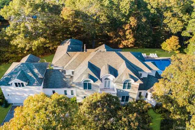an aerial view of multiple houses with a yard
