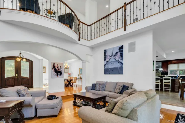 a living room with furniture and a large window with wooden floor