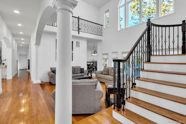a view of entryway and hall with wooden floor