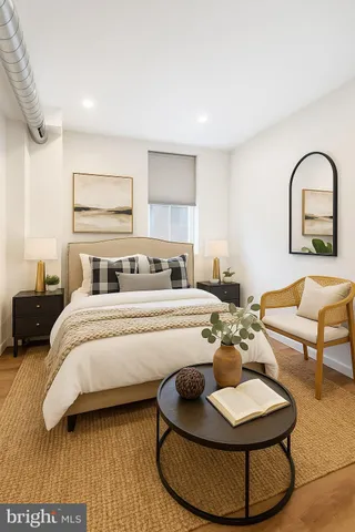 a bedroom with a bed and a couch