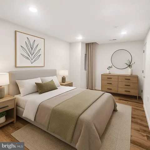 a bedroom with a bed and painting on the wall