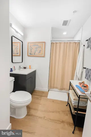a bathroom with a toilet sink and shower