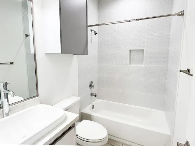 a bathroom with a sink a toilet and a bathtub