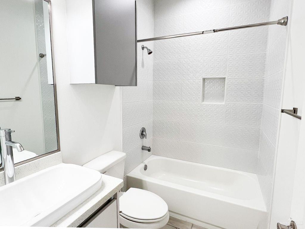 1723 West Marlin Street, Unit 3 Pharr, TX 78577 - Photo 4 of 7 a bathroom with a sink a toilet and a bathtub