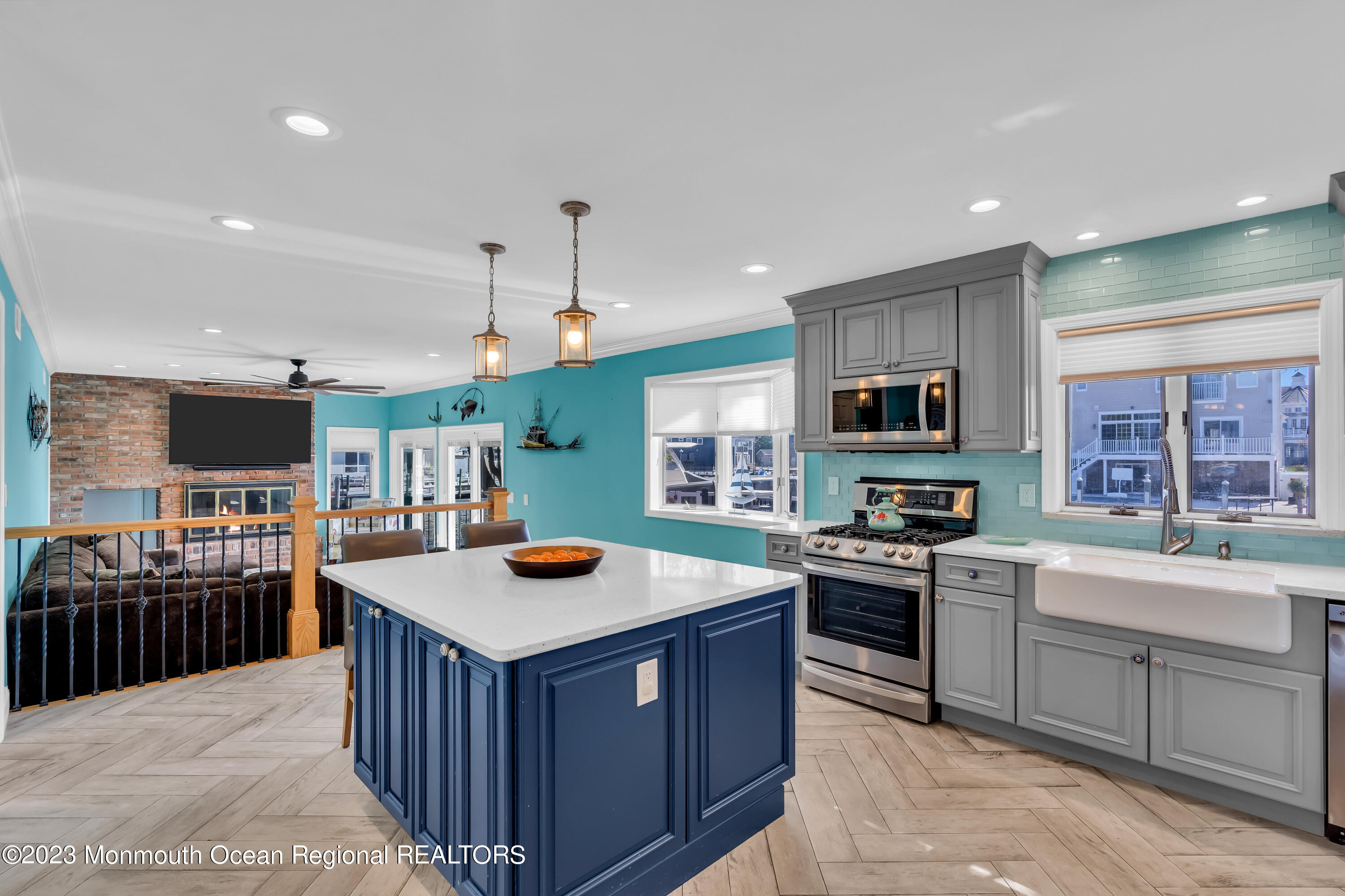 1801 Boat Point Drive Point Pleasant, NJ 08742 - Photo 18 of 76 a kitchen with stainless steel appliances granite countertop a stove top oven a sink dishwasher a dining table and chairs with wooden floor