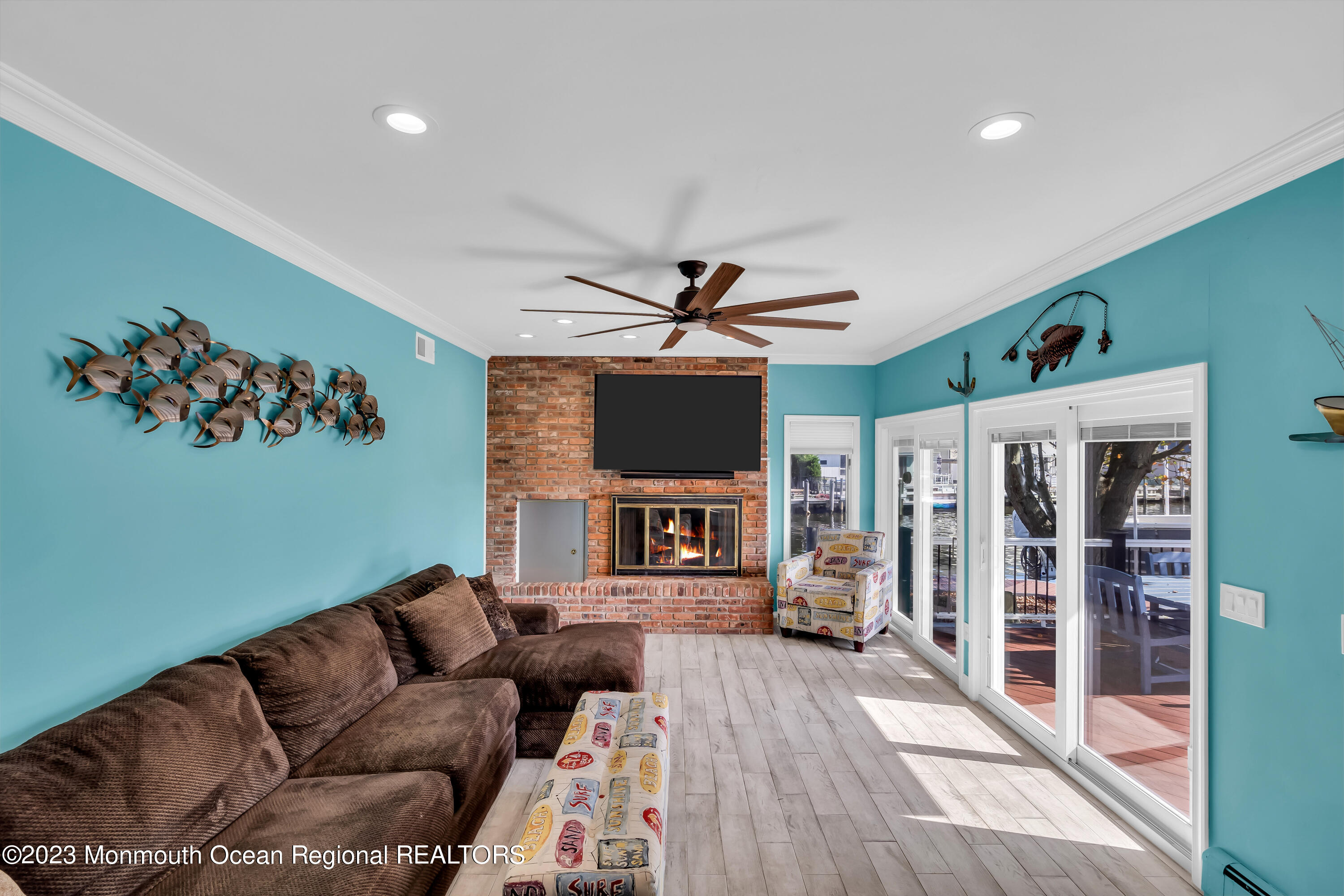1801 Boat Point Drive Point Pleasant, NJ 08742 - Photo 24 of 76 a living room with furniture a fireplace and a flat screen tv