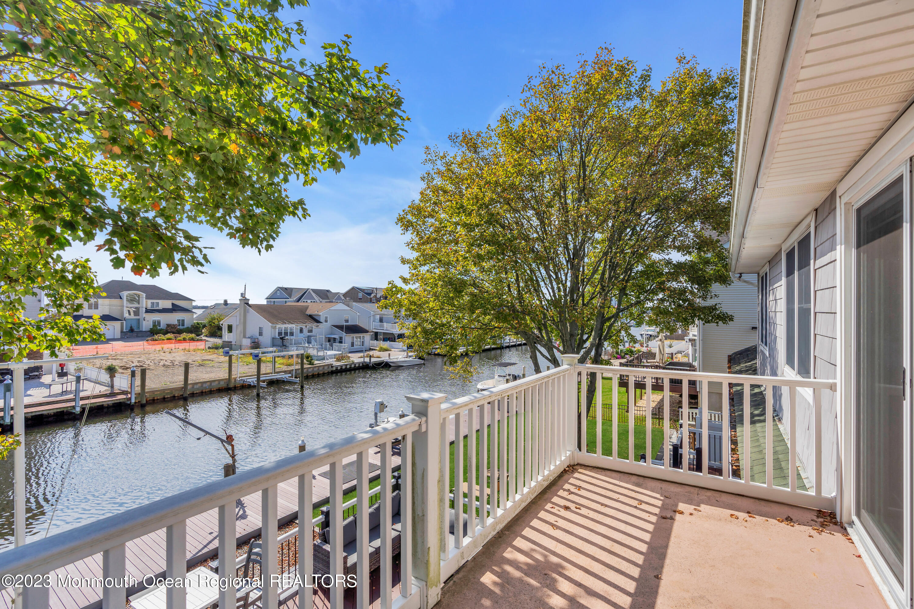 1801 Boat Point Drive Point Pleasant, NJ 08742 - Photo 39 of 76 a view of a house with wooden deck and furniture