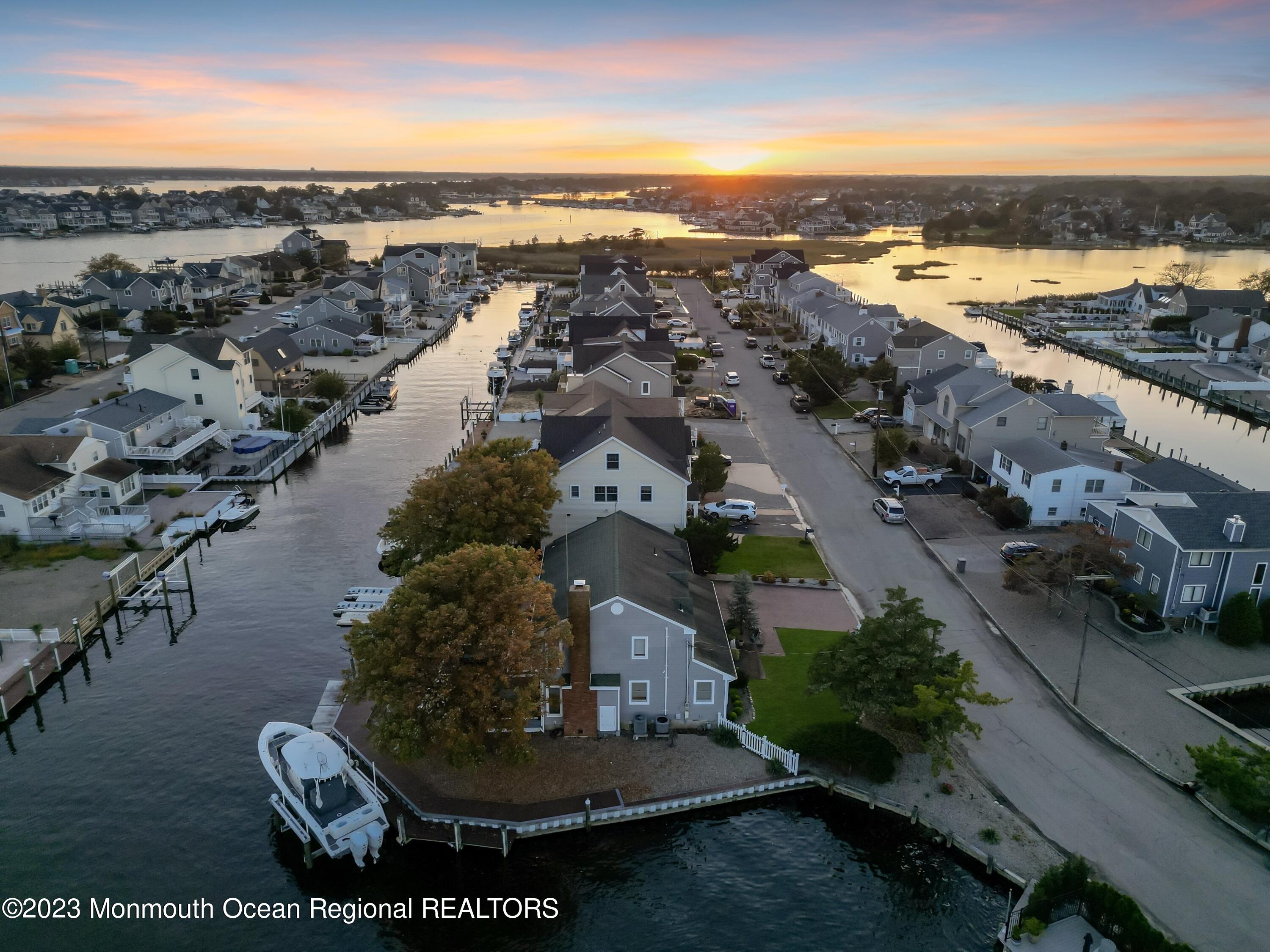 1801 Boat Point Drive Point Pleasant, NJ 08742 - Photo 59 of 76 an aerial view of a city with lots of residential buildings ocean and mountain view in back