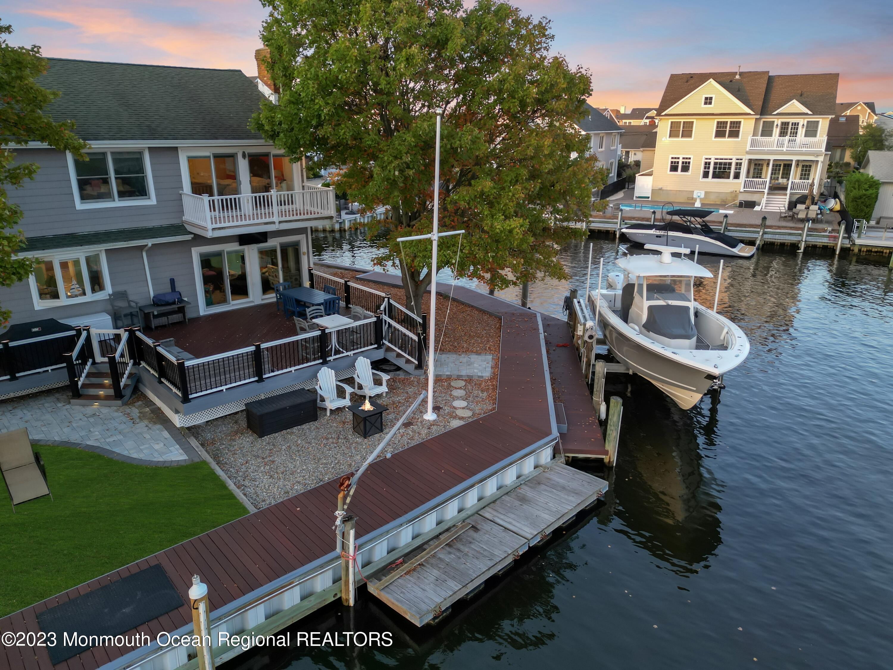 1801 Boat Point Drive Point Pleasant, NJ 08742 - Photo 64 of 76 a view of a patio with table and chairs with wooden floor and fence