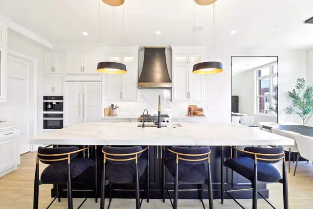 a dining table with chairs and painting on the wall