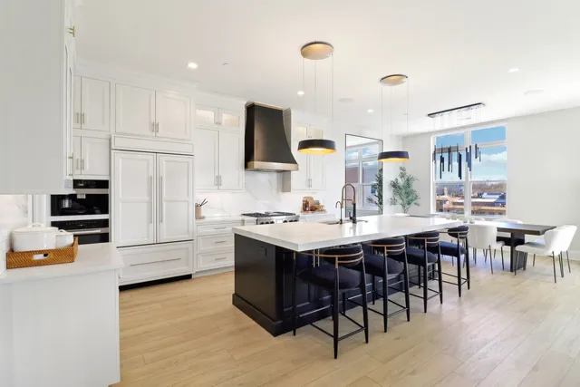 a large kitchen with a table and chairs