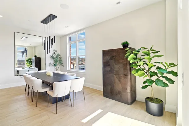 a dining room with furniture and potted plant