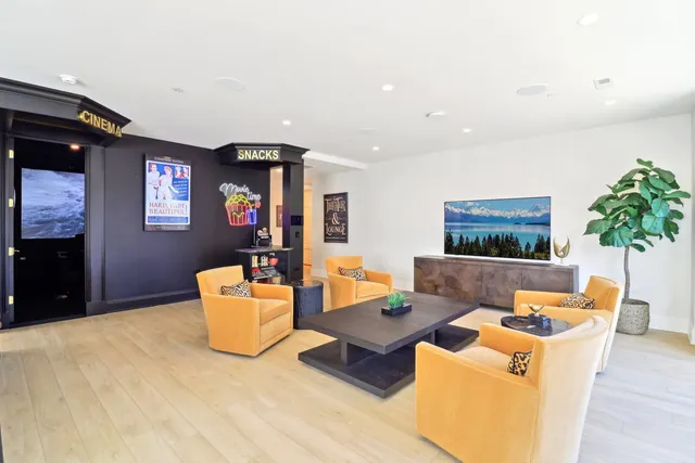 a living room with furniture and a floor to ceiling window