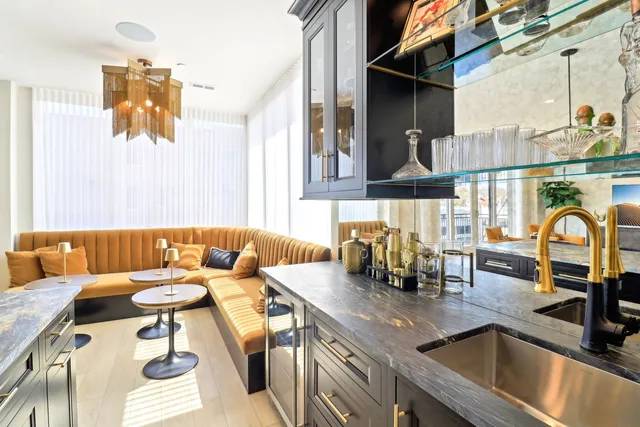 a kitchen with a table chairs stove and wooden floor