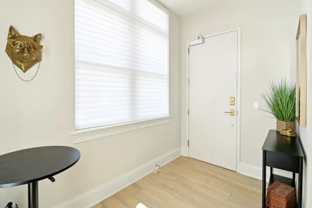 a view of a room with wooden floor and a window
