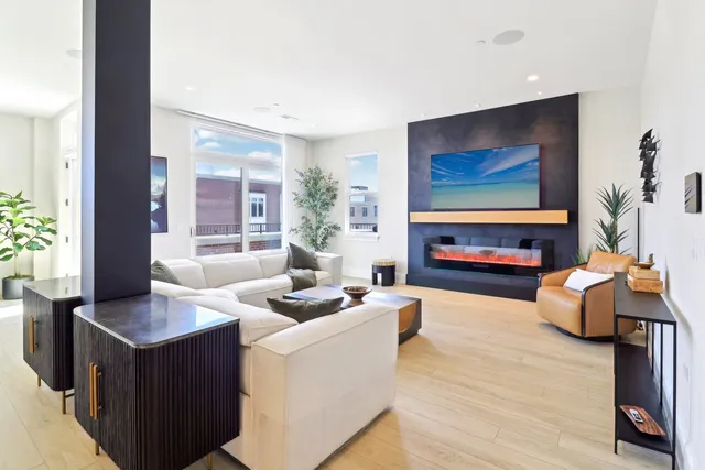a living room with furniture a fireplace and a flat screen tv