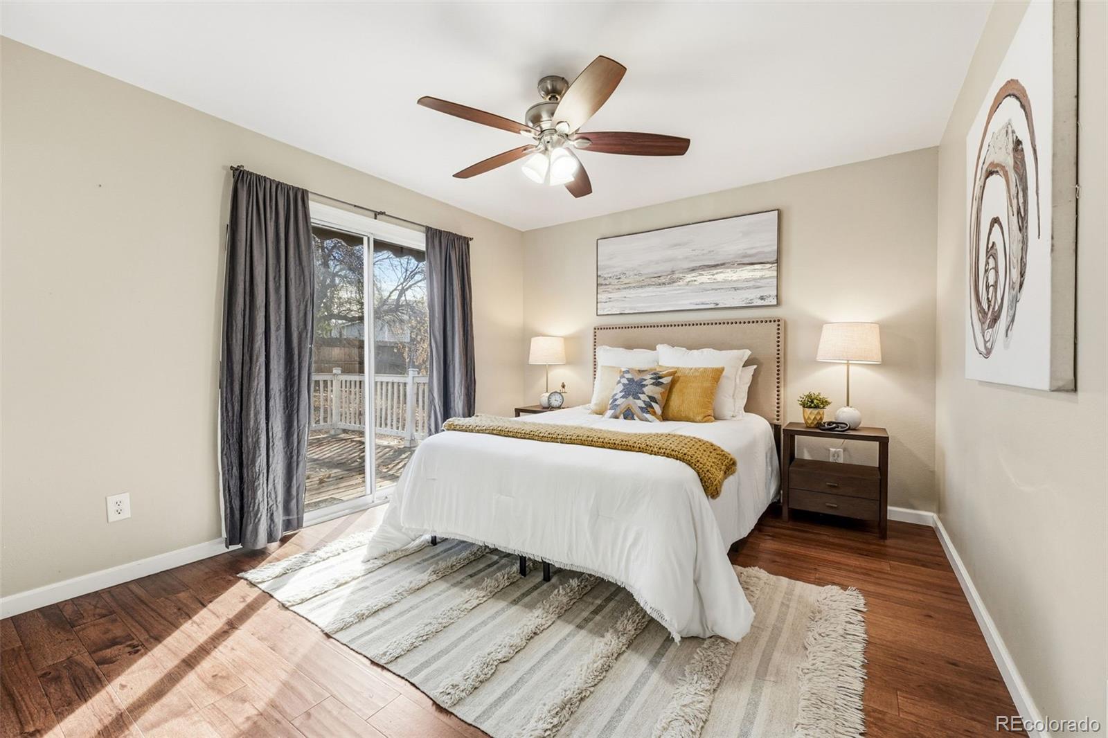 17660 Snowberry Way Parker, CO 80134 - Photo 20 of 38 a bedroom with a large bed and a large window