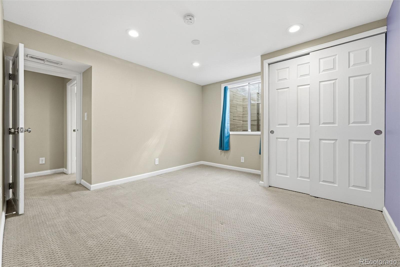17660 Snowberry Way Parker, CO 80134 - Photo 28 of 38 an empty room with windows and closet