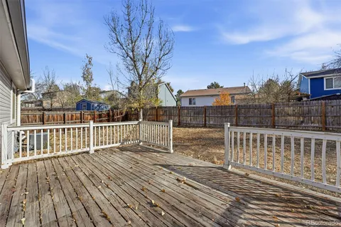 a view of deck with wooden floor and fence and floor to ceiling window