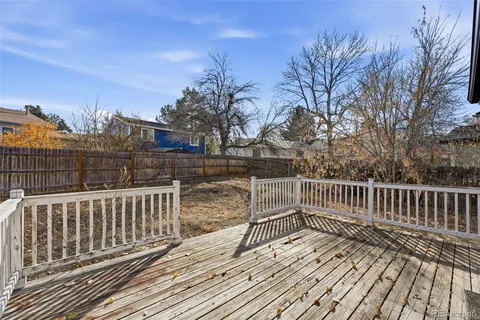 a view of a brick house with wooden fence