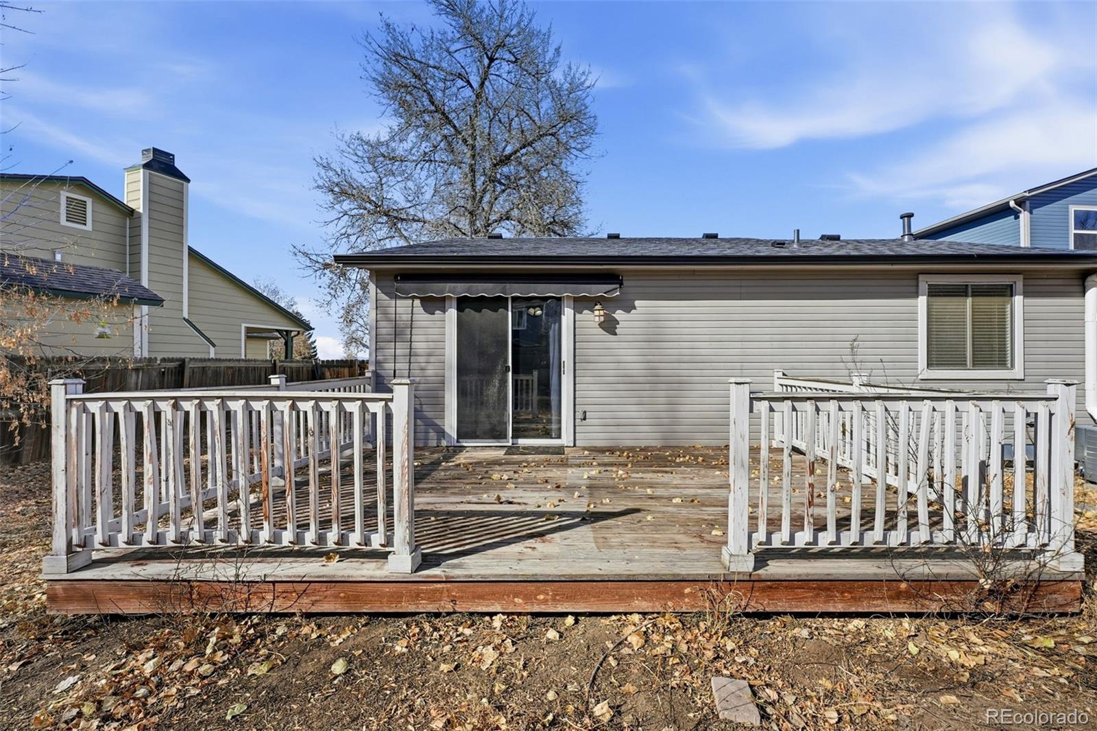 17660 Snowberry Way Parker, CO 80134 - Photo 34 of 38 a view of a brick house with wooden fence