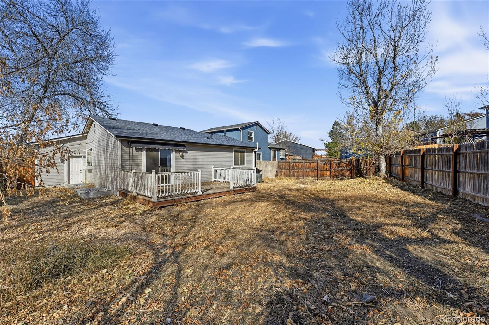17660 Snowberry Way Parker, CO 80134 - Photo 37 of 38 a view of a yard with a house and a tree