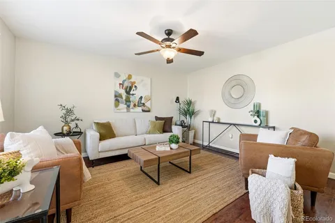 a living room with furniture and a clock