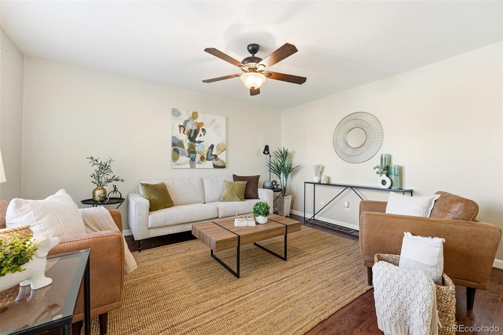 17660 Snowberry Way Parker, CO 80134 - Photo 6 of 38 a living room with furniture and a clock