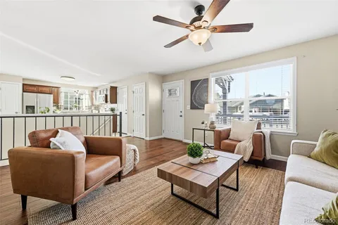 a living room with furniture and a book shelf