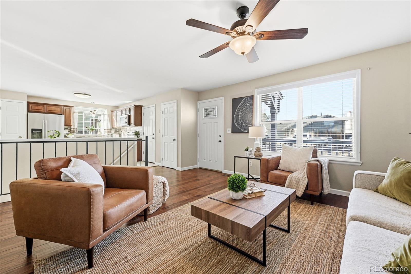 17660 Snowberry Way Parker, CO 80134 - Photo 10 of 38 a living room with furniture and a book shelf