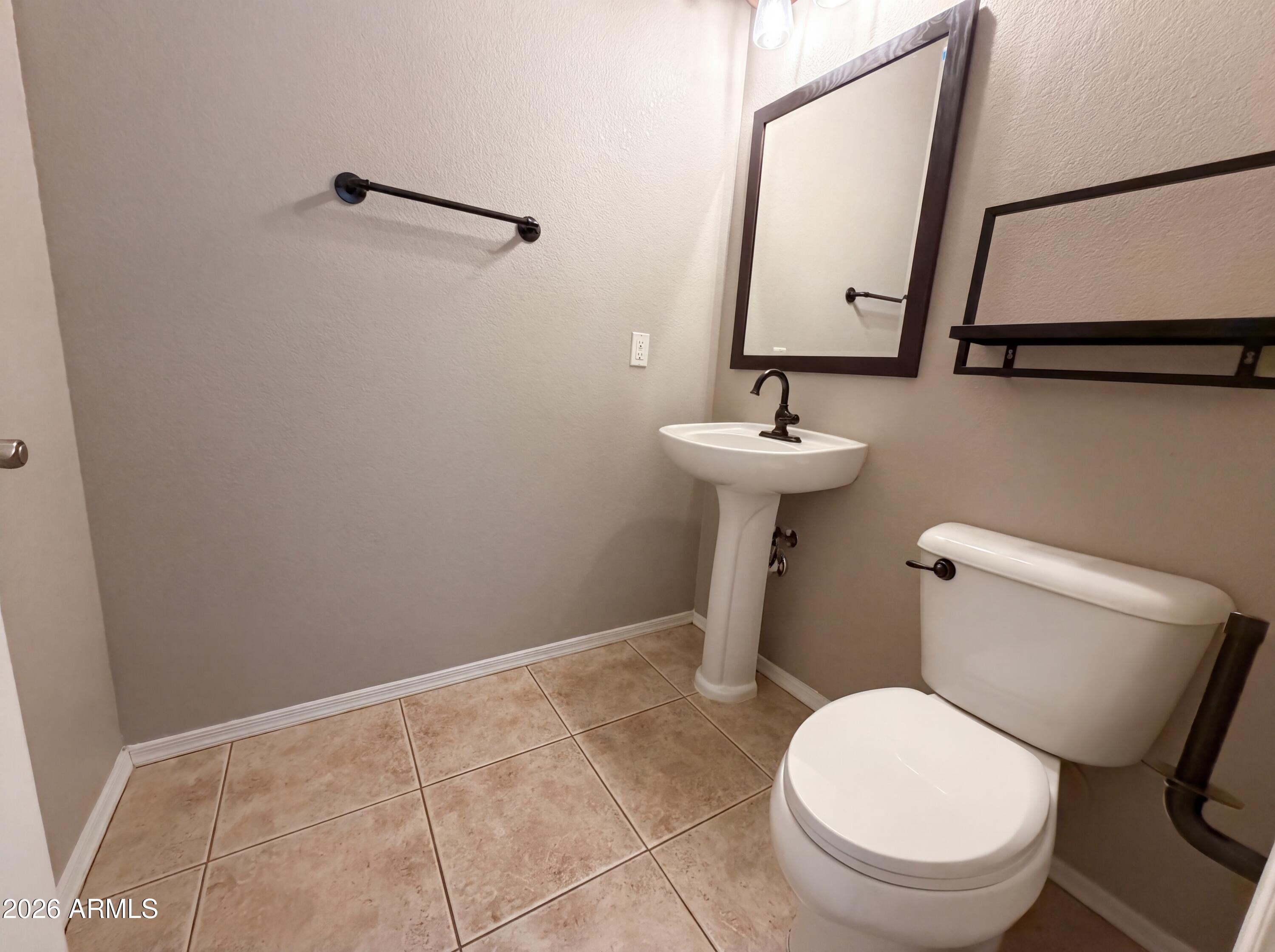 1565 East Hopkins Road Gilbert, AZ 85295 - Photo 23 of 29 a bathroom with a toilet sink and mirror