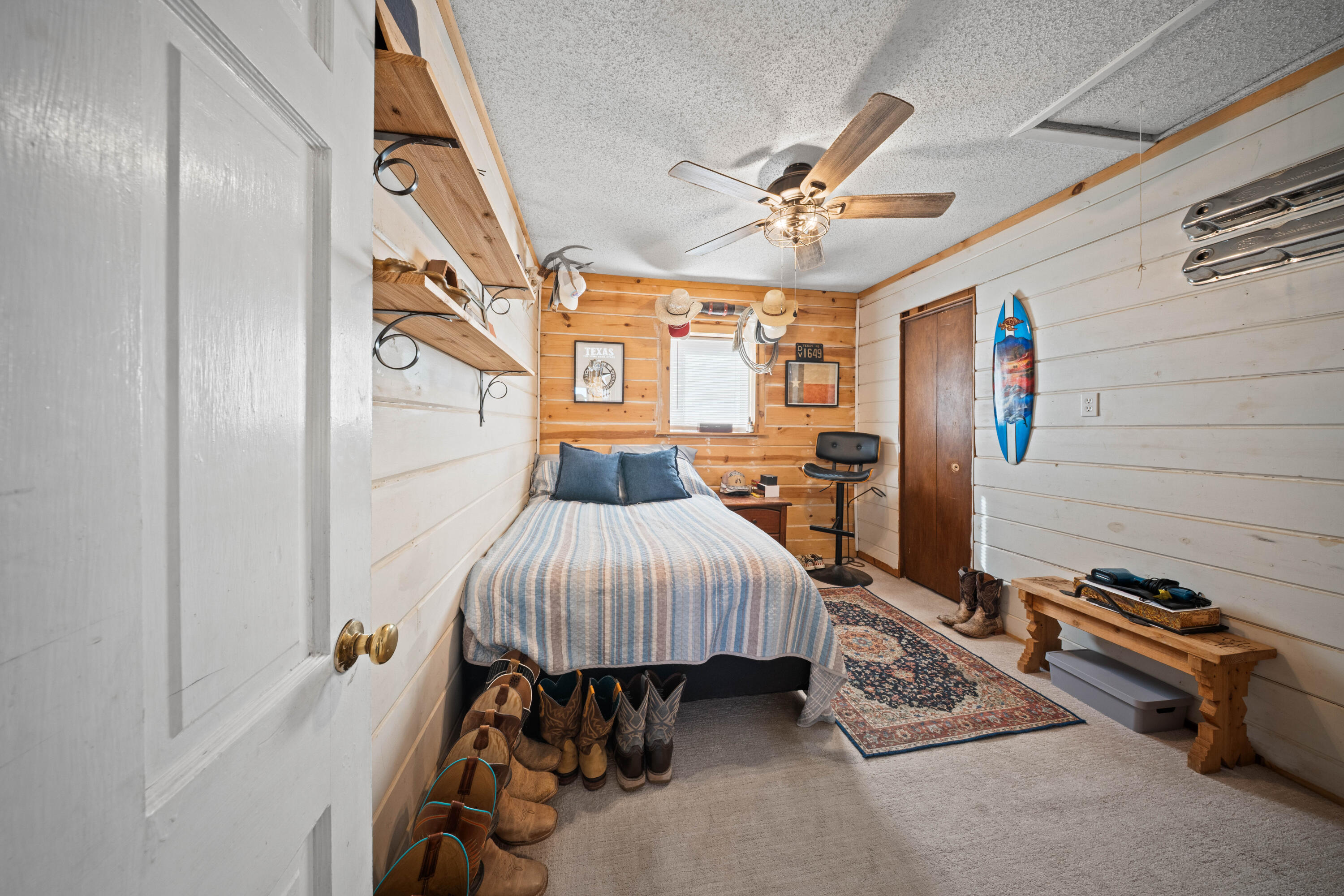 3725 Hawk Road Ropesville, TX 79358 - Photo 29 of 39 a bedroom with a bed and a chandelier