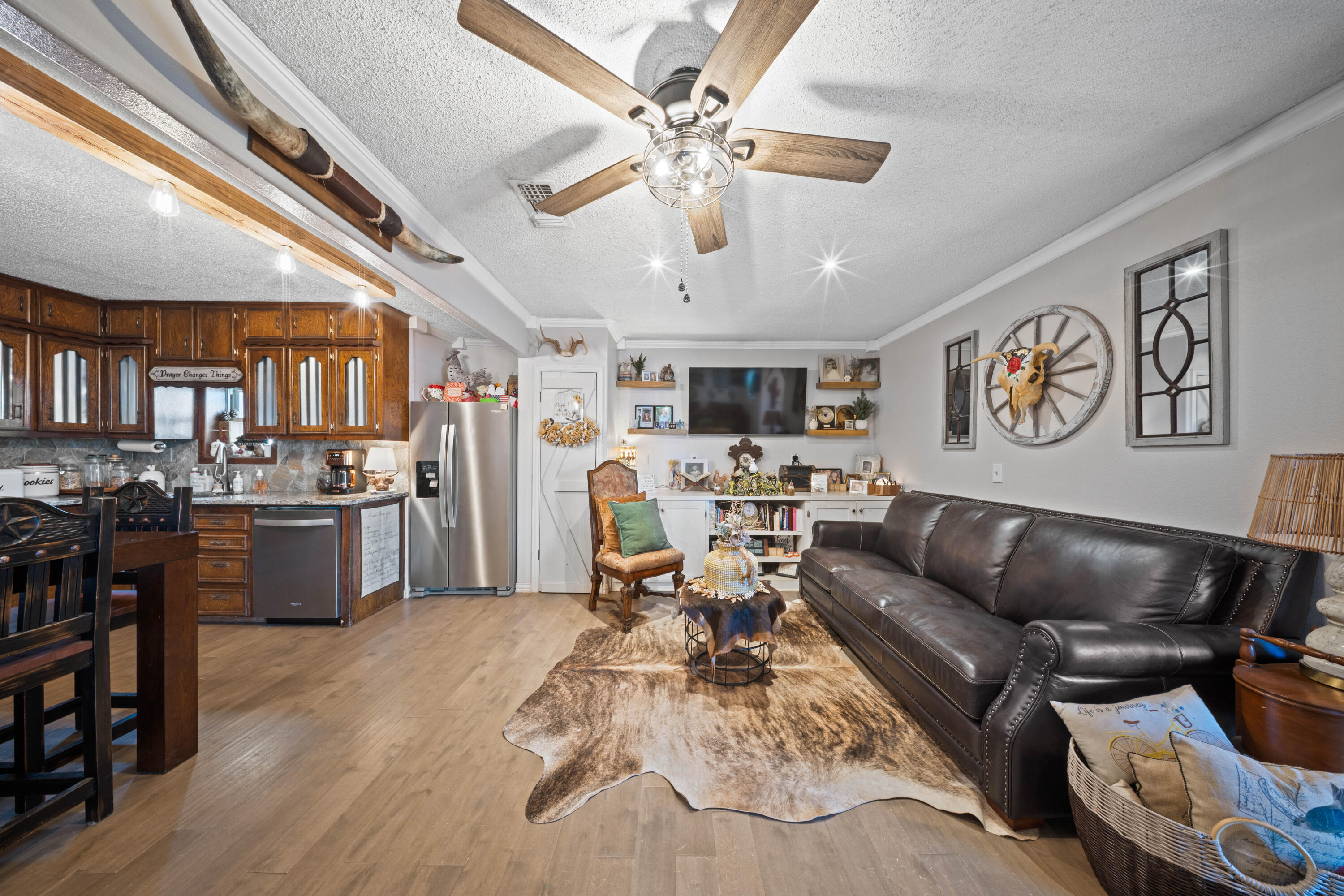 3725 Hawk Road Ropesville, TX 79358 - Photo 9 of 39 a living room with furniture kitchen view and a chandelier