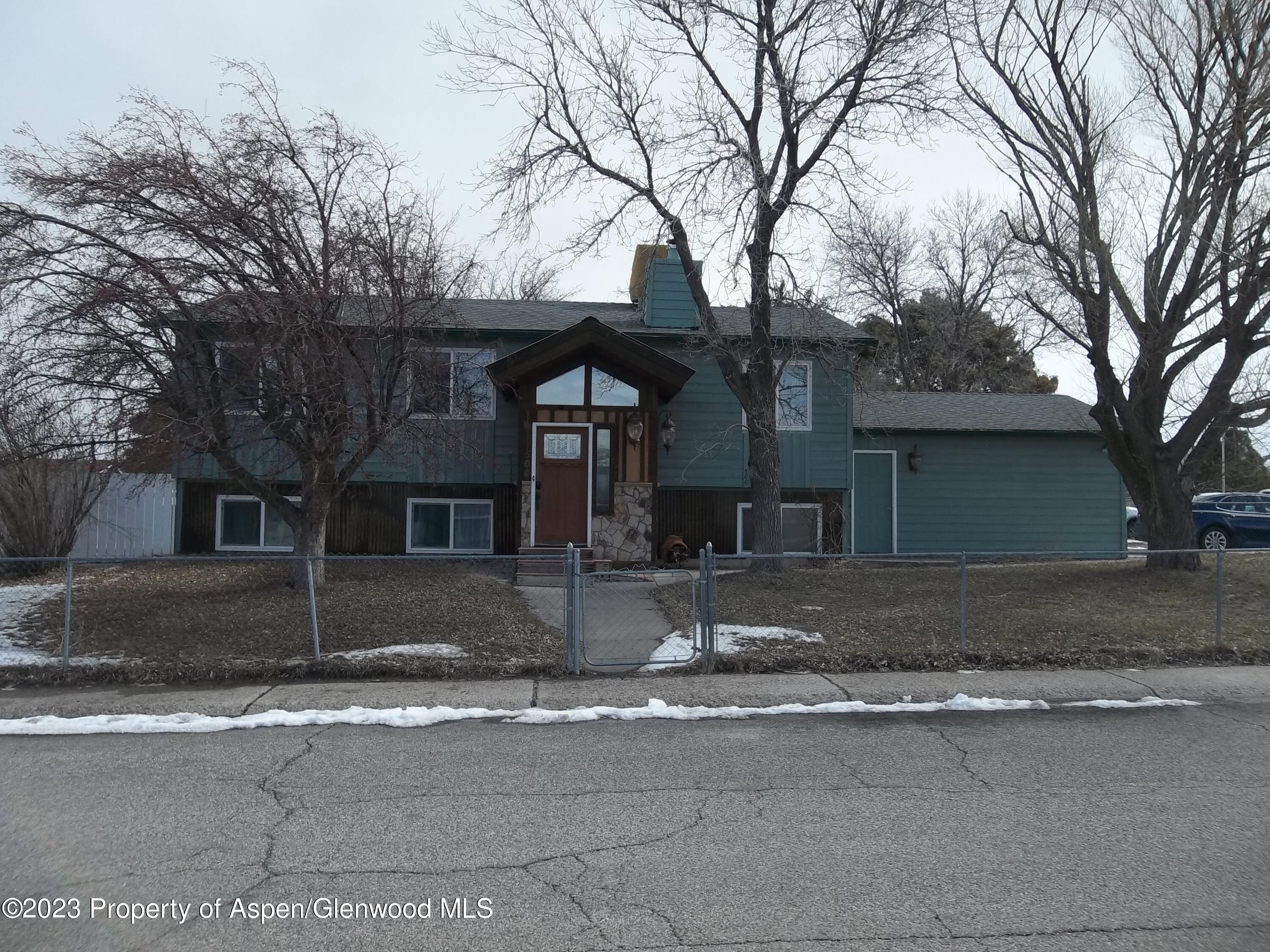 500 Wamsley Way Rifle, CO 81650 - Photo 1 of 21 a front view of a house with yard and trees