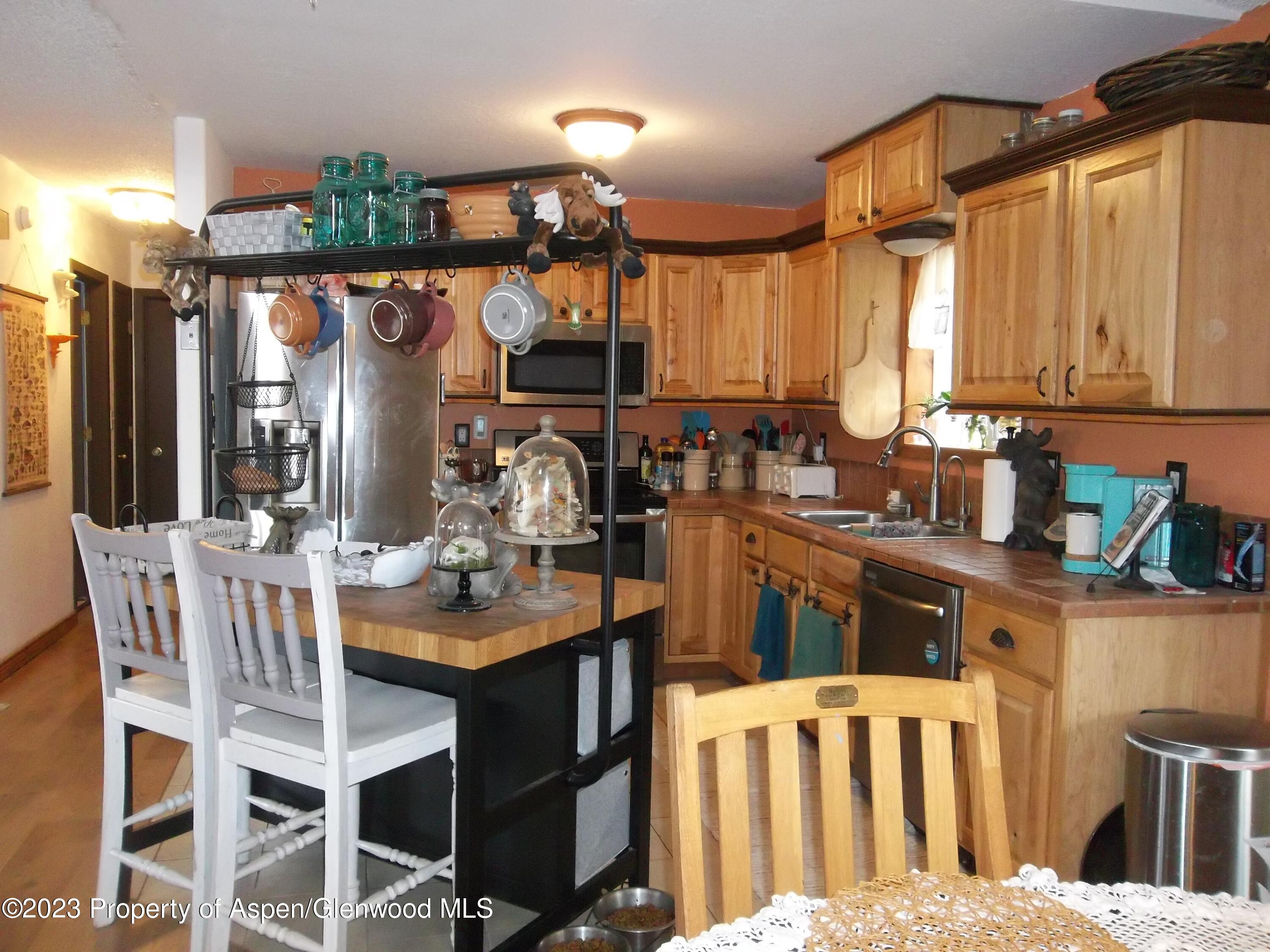 500 Wamsley Way Rifle, CO 81650 - Photo 3 of 21 a kitchen with a table chairs and a wooden floor