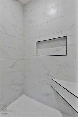 a bathroom with a bathtub and shower